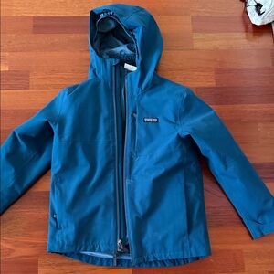 Patagonia Teal Blue snowboarding jacket with Liner that can be removed.